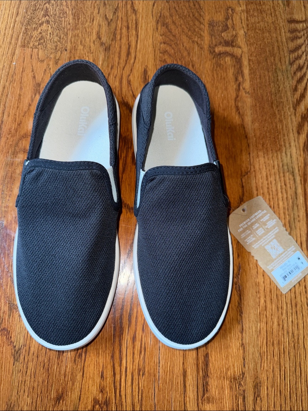 OluKai Women’s Slip-On Loafers in Black with White Trim